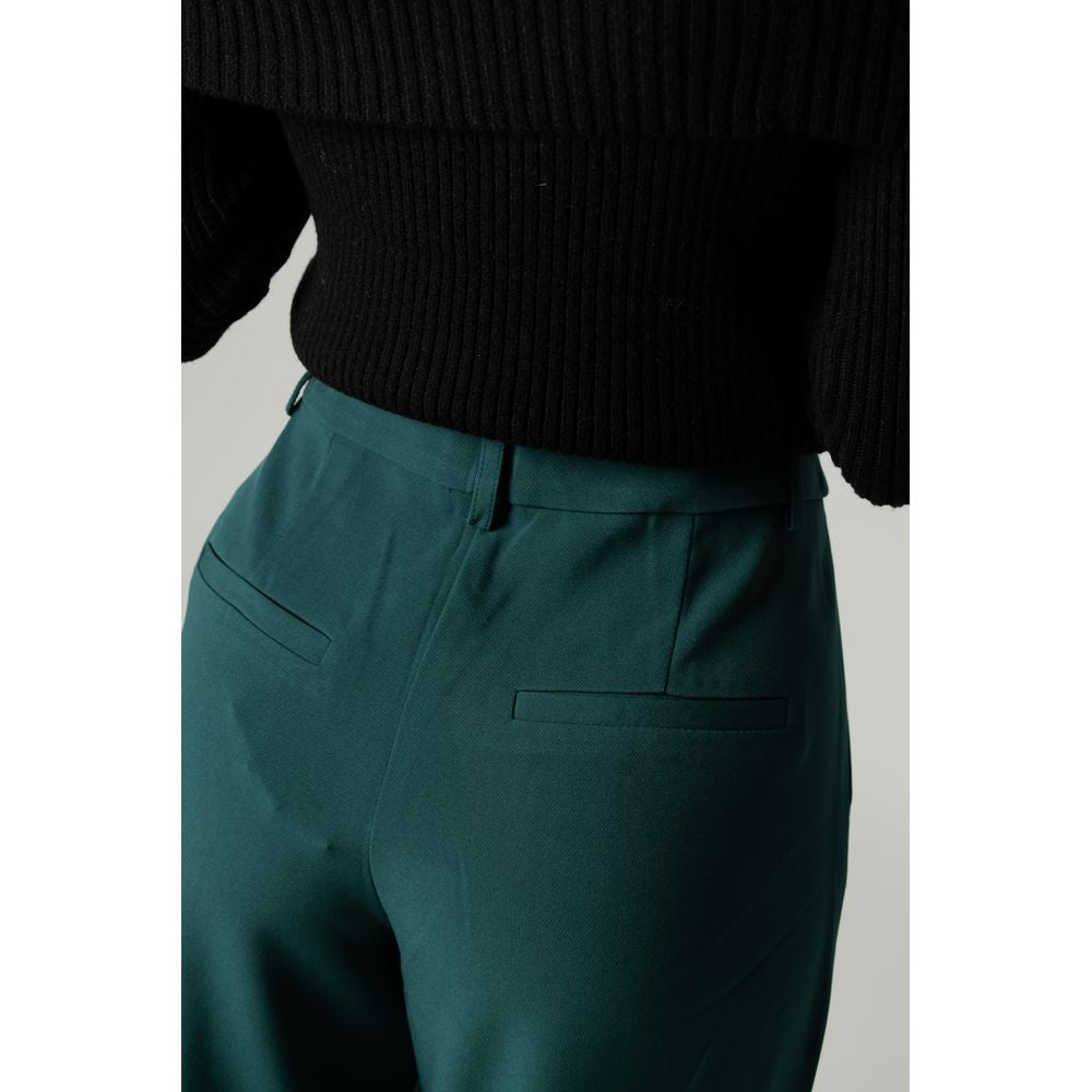 Woman wearing Vila Clothes green recycled polyester bootcut pants for autumn/winter season