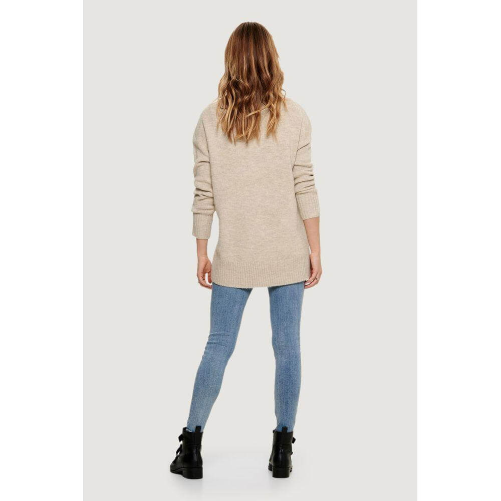 Back view of a woman wearing an Only Beige Acrylic Sweater and jeans, showcasing a stylish and versatile long-sleeve fashion choice.