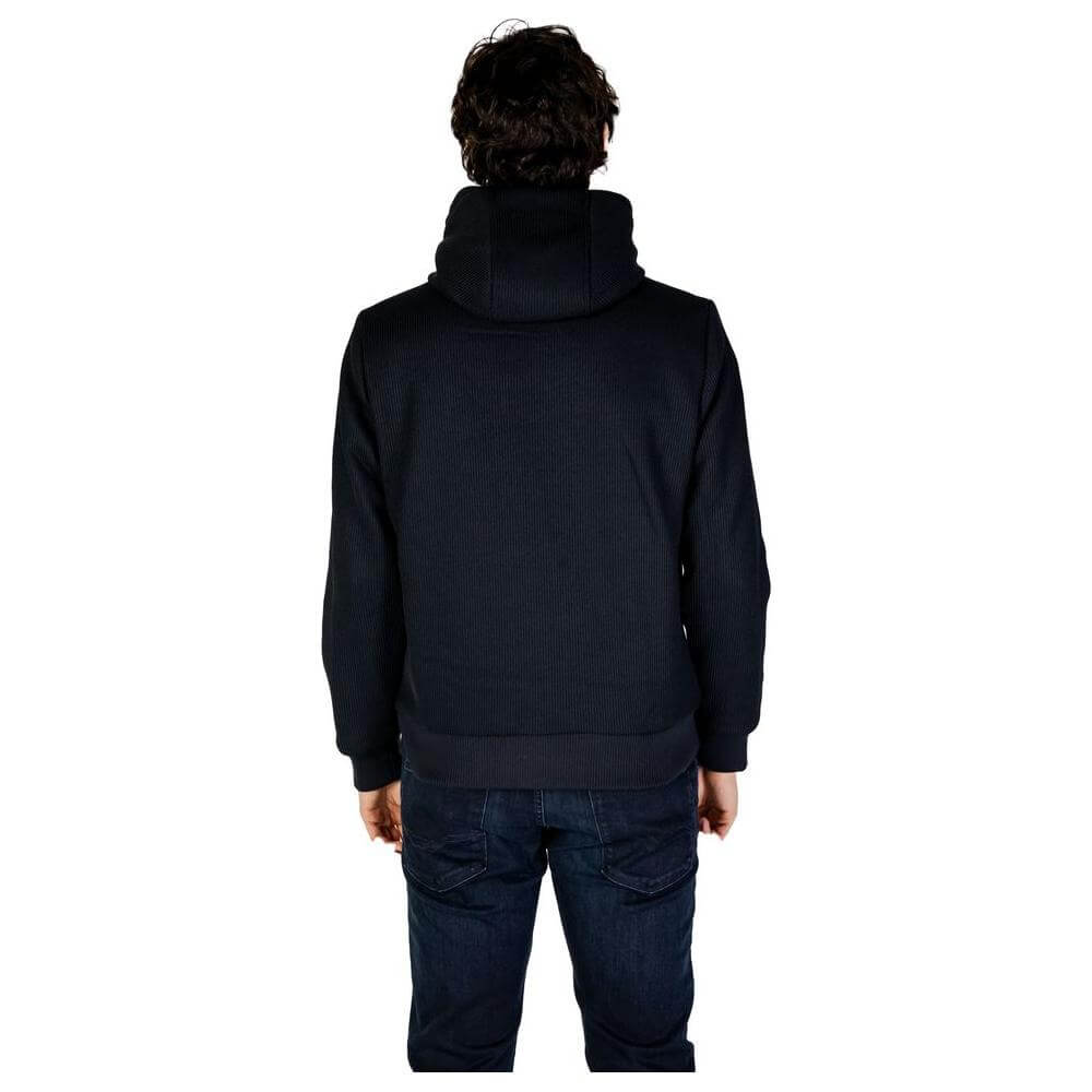 Back view of a man wearing a Hydra Clothing blue polyester jacket, part of the men's fall/winter collection.