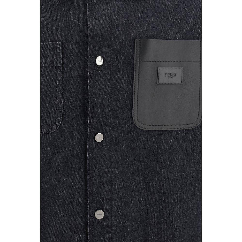 Fendi denim jacket close-up, featuring snap-button closure and a leather pocket with iconic logo detailing on dark denim fabric.