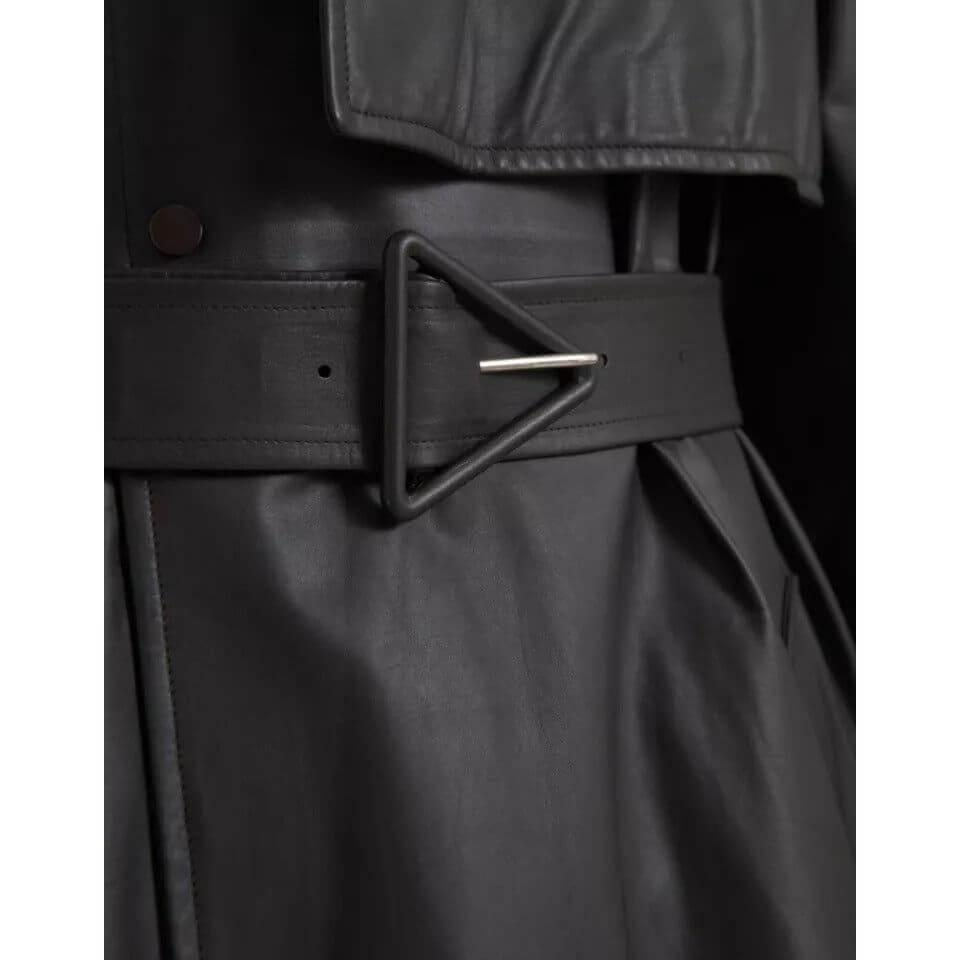 Close-up of Bottega Veneta black leather men's trench coat with unique belt and button details, luxury Italian fashion.