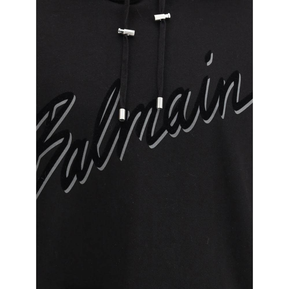 Balmain Logo cotton hoodie with drawstring hood and iconic printed logo, featuring ribbed hems for a refined streetwear look.
