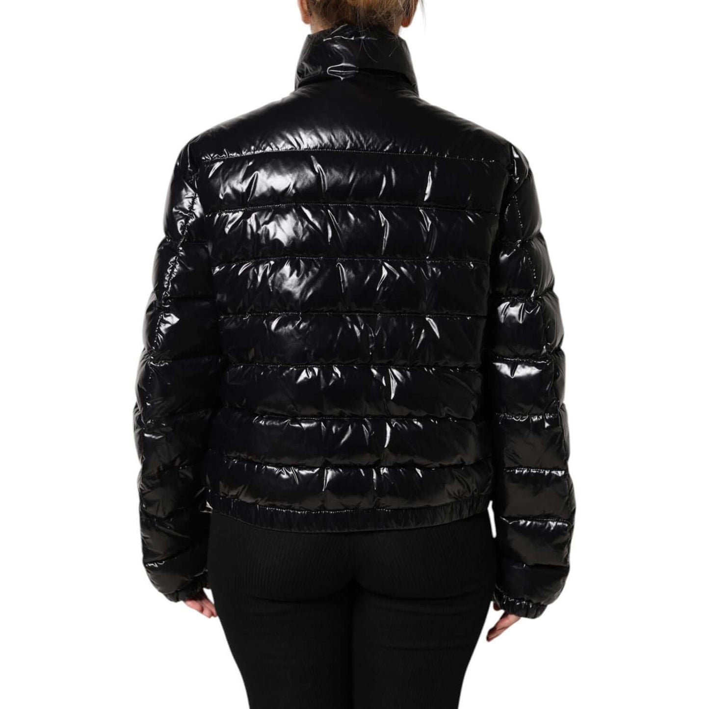 Back view of Dolce & Gabbana black full zip puffer jacket with logo plaque, long sleeves, glossy finish, made in Italy.