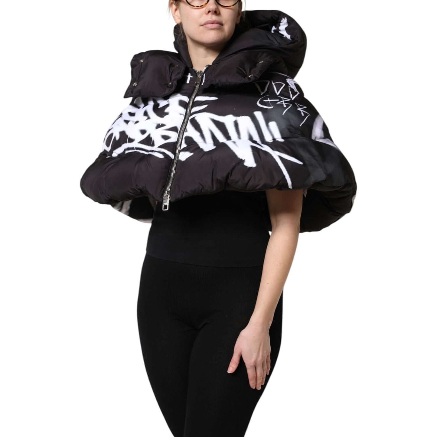 Dolce & Gabbana black padded hooded cropped jacket with full zip, featuring logo details, made in Italy, worn by a model.