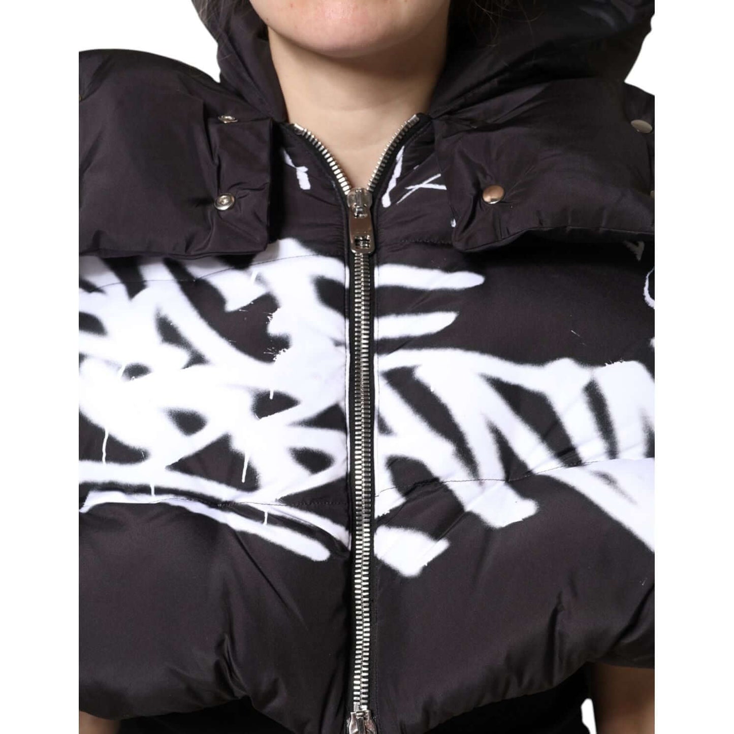 Dolce & Gabbana black padded hooded cropped jacket with full zip, featuring white graffiti print and high craftsmanship, made in Italy.