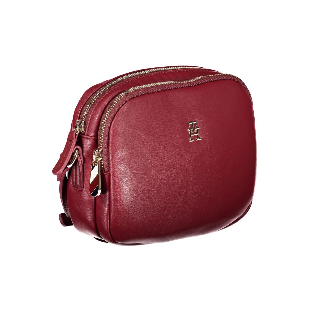 Tommy Hilfiger Red Polyester Handbag with adjustable strap, two compartments, and zip closure featuring logo on the front.