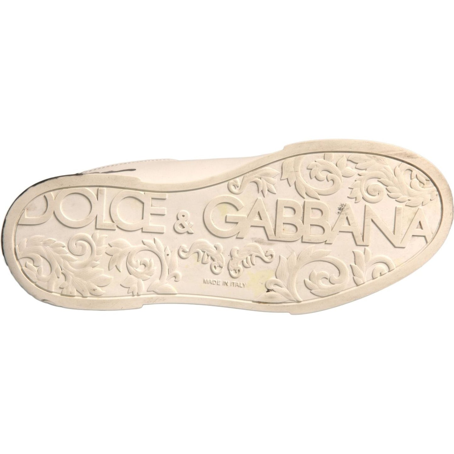 Dolce & Gabbana white sneaker sole with embossed logo and floral design, showcasing luxury craftsmanship.