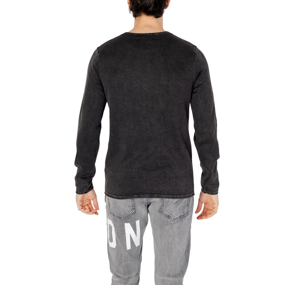 Man wearing Jack Jones Black Cotton Sweatshirt, showcasing back view, crew neck, long sleeves, fine knit texture, casual style outfit