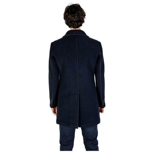 Back view of model wearing Hydra Clothing Blue Wool Jacket, men's fall/winter collection, made of wool, polyester, and synthetic fibers.