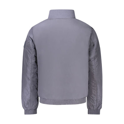 Calvin Klein Blue Polyamide Men Jacket with sleek design and zip closure, featuring bold logo and contrasting details to stand out.