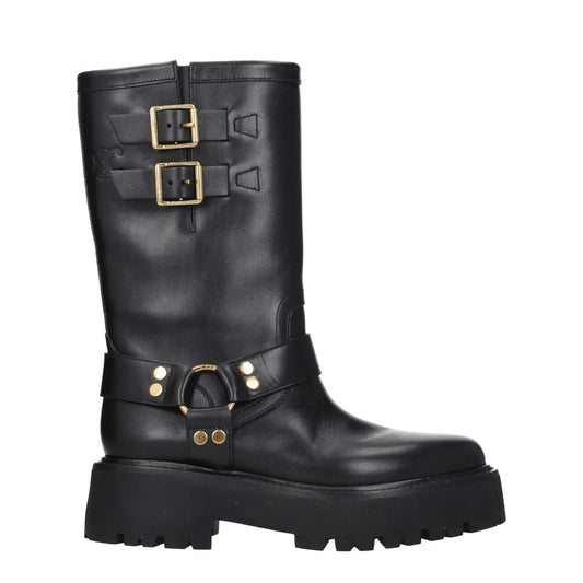 Black leather ankle boots with gold buckle and strap details. Round toe, lug sole, mid-calf height. Ideal for edgy casual wear.
