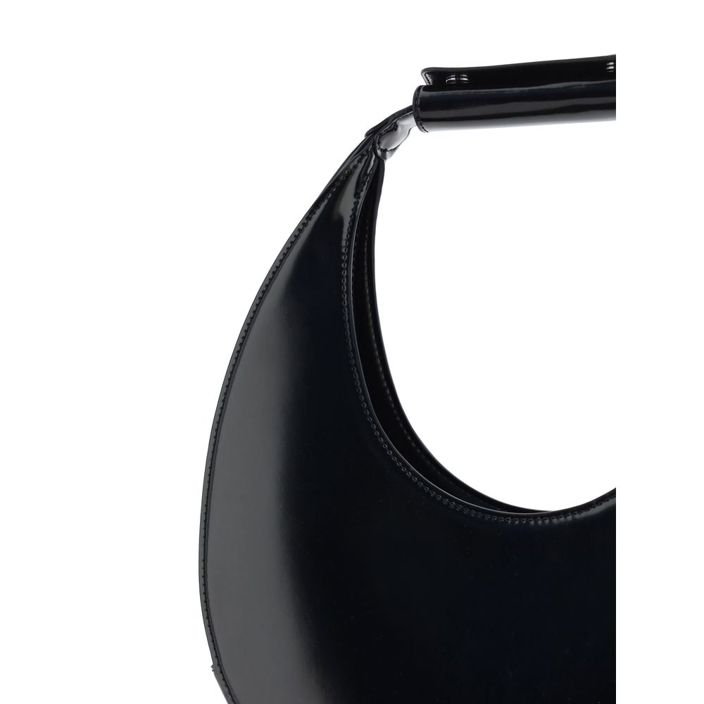 Close-up view of Staud Black Calf Leather Bos Taurus Shoulder Bag with iconic moon shape and rigid handle.