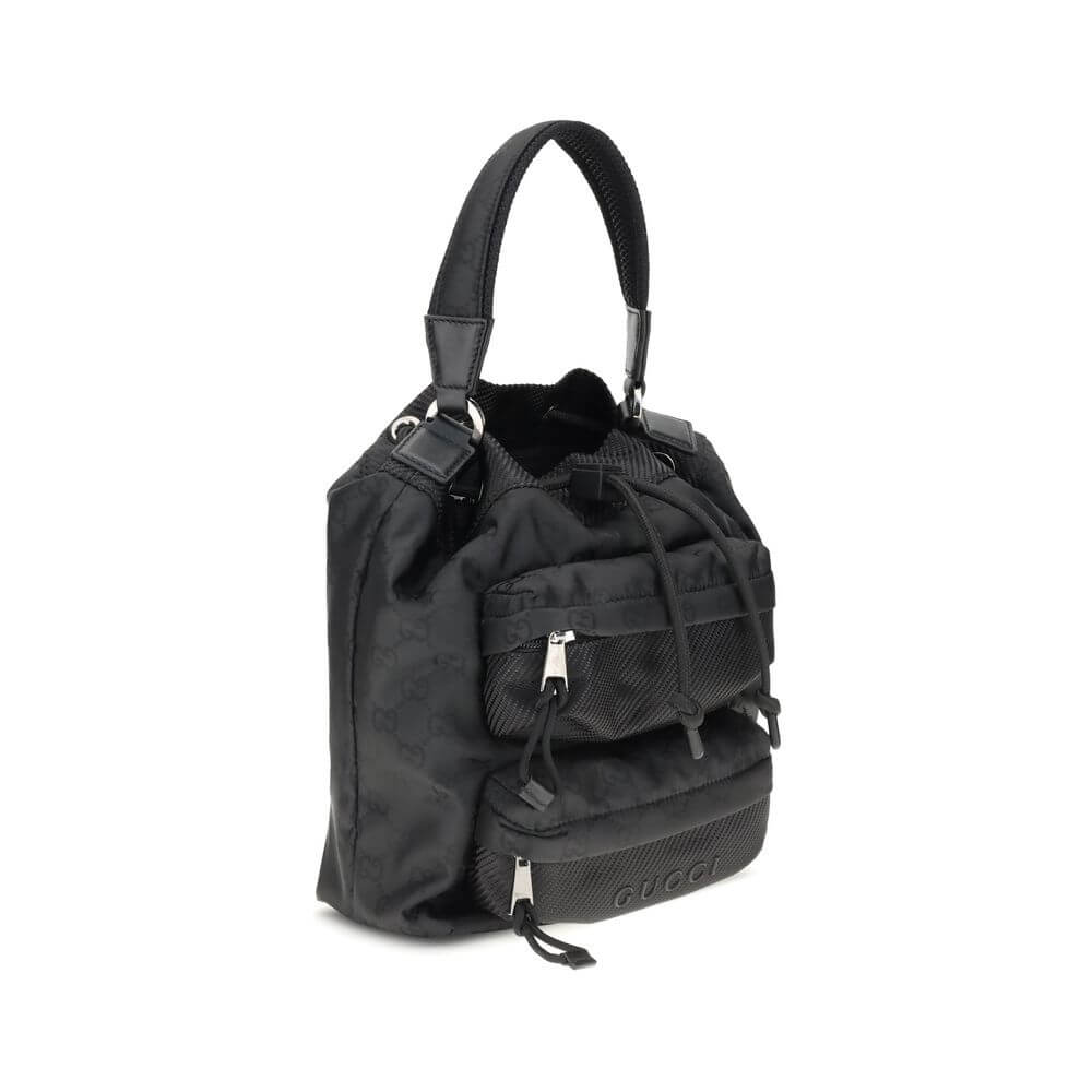 Gucci Black Polyamide Backet Bag with GG Supreme pattern, featuring drawstring closure, rigid handle, and front zippered pockets.