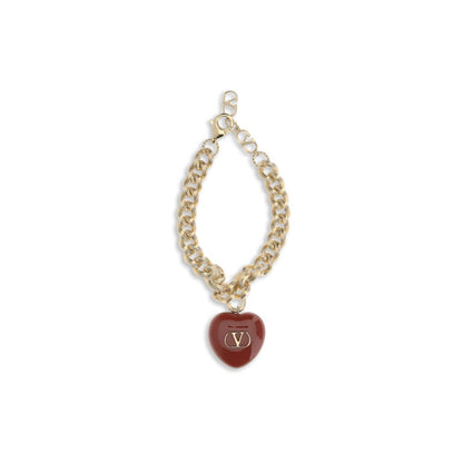 Valentino Garavani Gold Brass Bracelet with black heart charm and Signature VLogo, elegant chain jewelry with swivel lobster clasp.