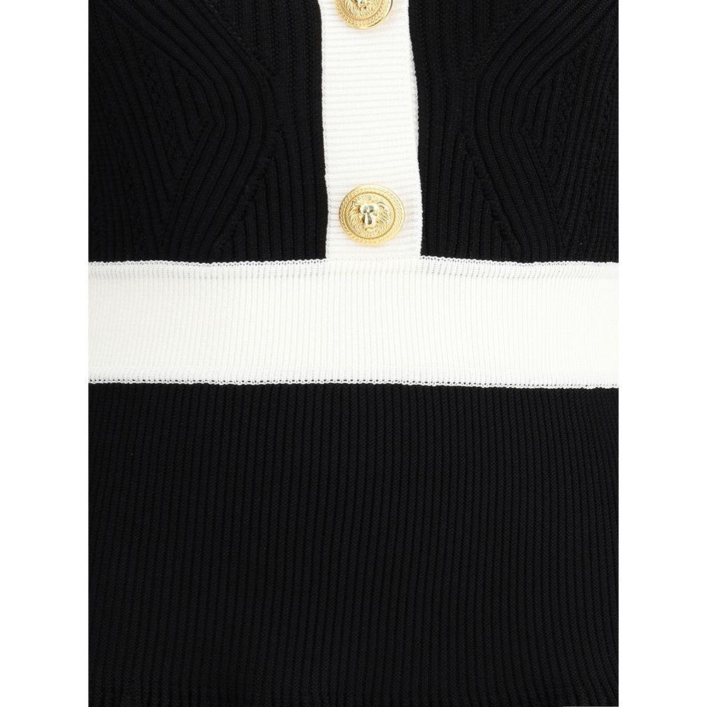 Close-up of Balmain Black Viscose Casual Dress featuring embossed buttons, ribbed trim, and structured knit detail.