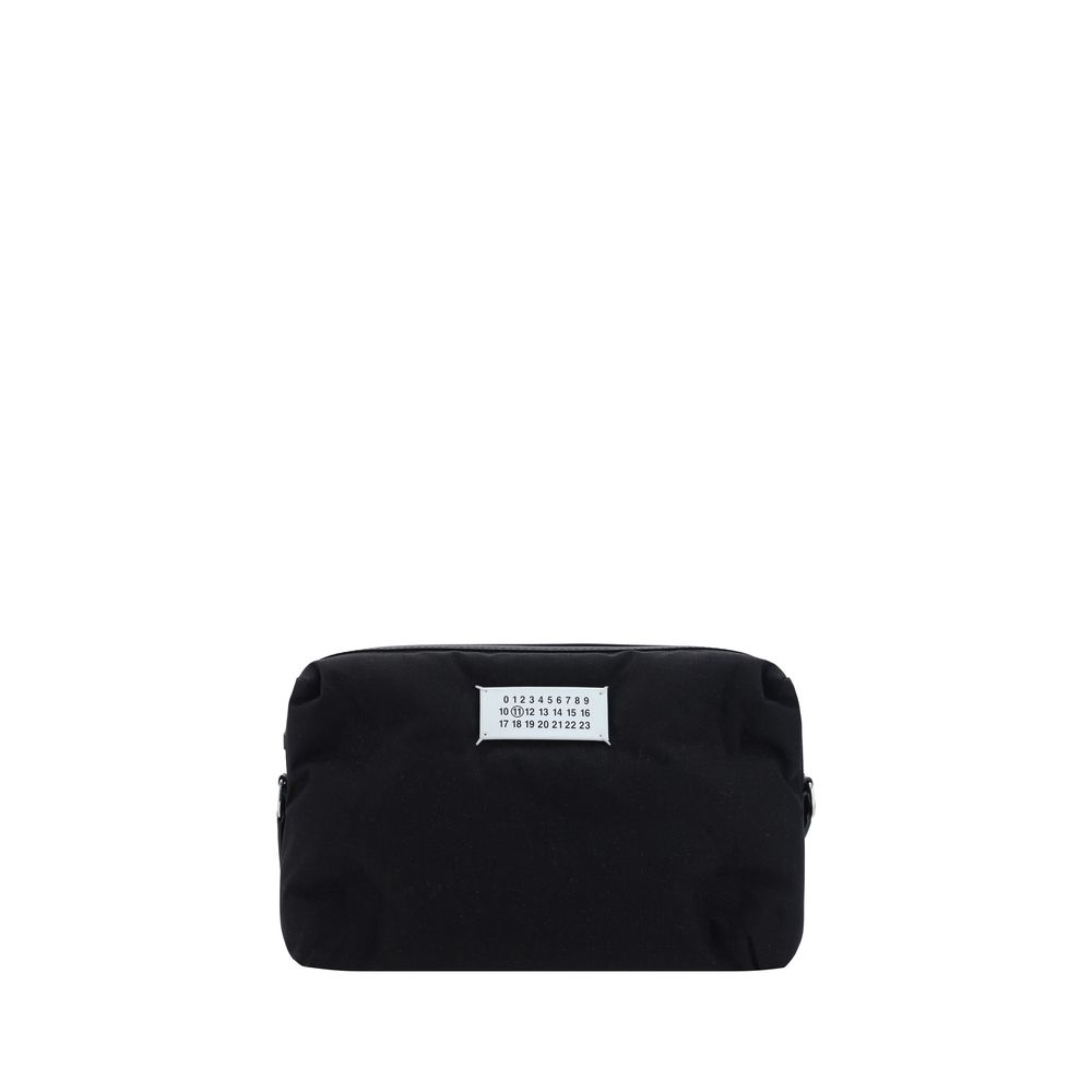 Margiela Black Nylon Shoulder Bag with contrasting logo label, zipper closure, and adjustable strap. AW25 season accessory.