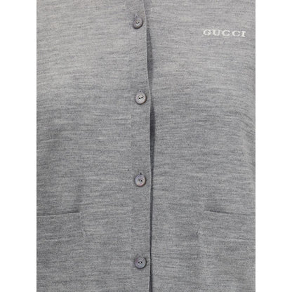 Close-up of Gucci Gray Cashmere Cardigan showing buttons and pockets, epitome of elegance and comfort with iconic stitched signature.