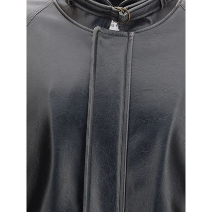 Close-up of MM6 Black Polyester Bomber with stand collar and buckle, showing tone-on-tone stitching and curved back yoke for structure and softness.
