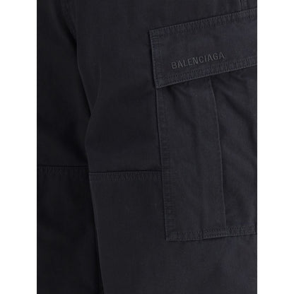 Balenciaga Black Cotton Cargo Pants with pockets and signature detailing on black denim, showcasing urban design aesthetics.