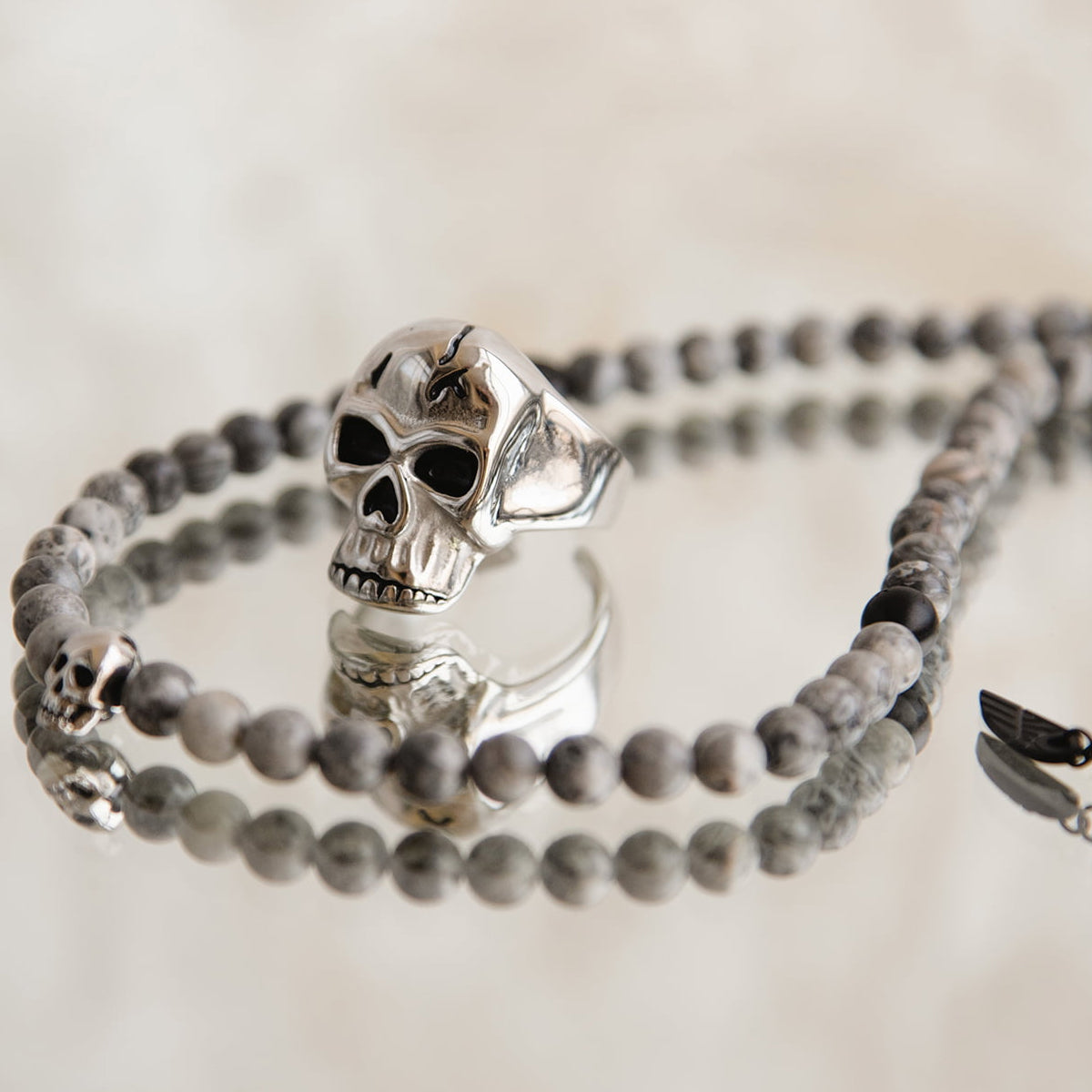 AN JEWELS JEWELRY Mod. AA.C255KGR skull ring and beaded bracelet set reflecting unique design.