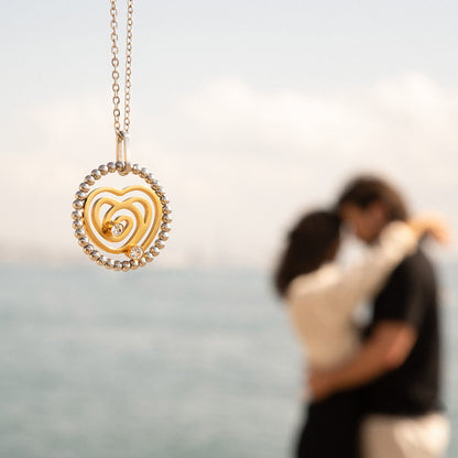 AN JEWELS JEWELRY Mod. AL.NSOKLSYC pendant with couple embracing in the background by the waterfront