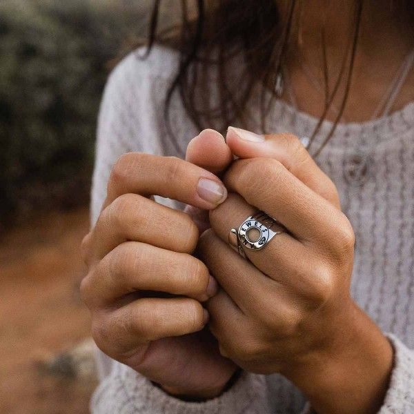 Close-up of hands wearing AN JEWELS JEWELRY Mod. AL.RFY01S-7 ring, showcasing intricate craftsmanship and stylish design.