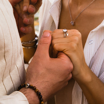 Couple holding hands, woman wearing AN JEWELS JEWELRY Mod. AL.RLFY01-8 ring, showcasing elegant design and romantic gesture.