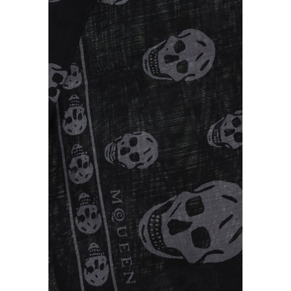 Close-up of Alexander McQueen Black Modal Scarf with skull motif, fringed edges, and logo. Made from silk and modal blend, size 120x120.