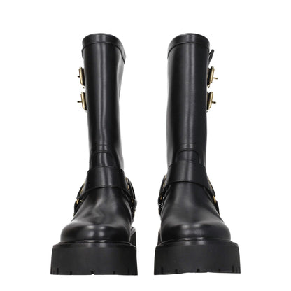 Front view of stylish black leather ankle boots with side detail and gold accents.