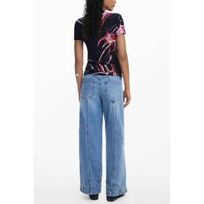 Back view of model wearing Desigual Black Viscose Women Top with signature print and blue jeans, showcasing bold and eclectic style.