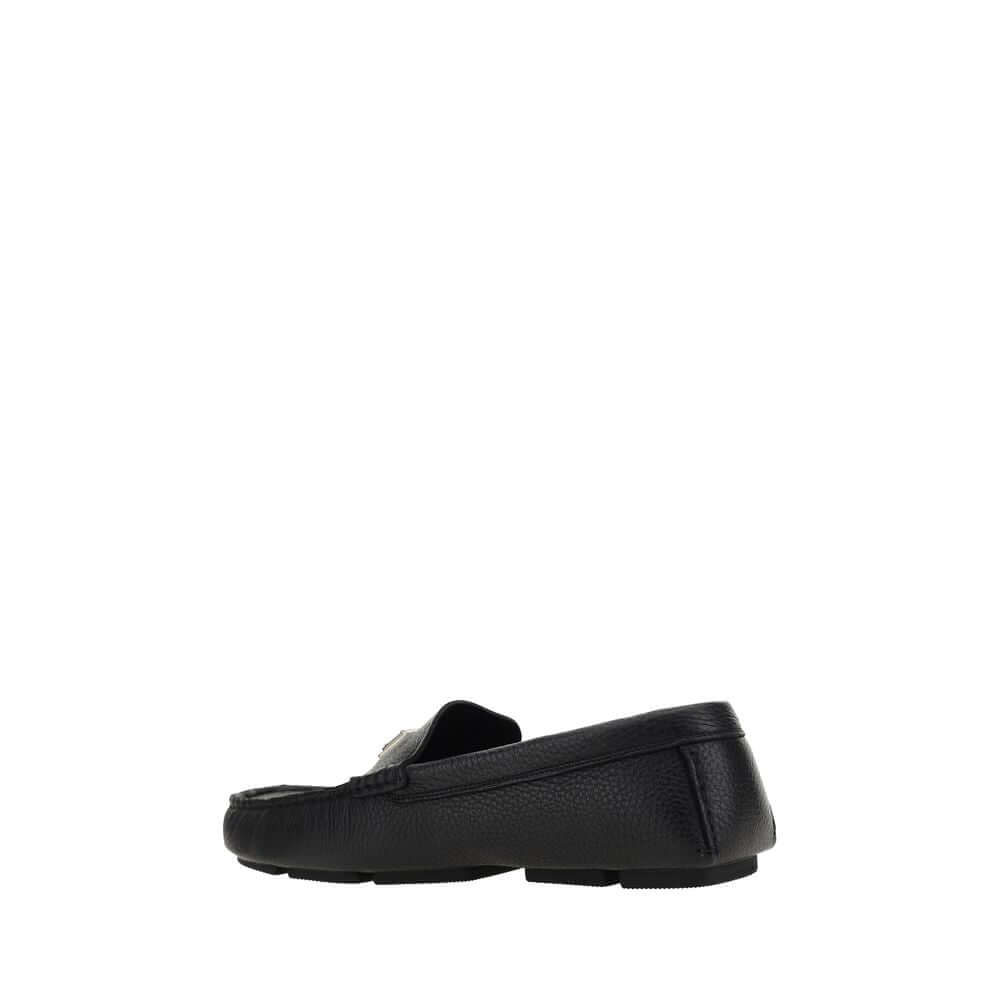 Dolce & Gabbana Black Rubber Slip-On Loafers with calfskin upper and non-slip sole, featuring iconic metal monogram plaque.