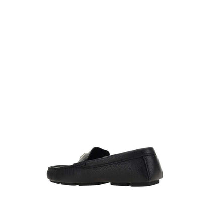 Dolce & Gabbana Black Rubber Slip-On Loafers with calfskin upper and non-slip sole, featuring iconic metal monogram plaque.