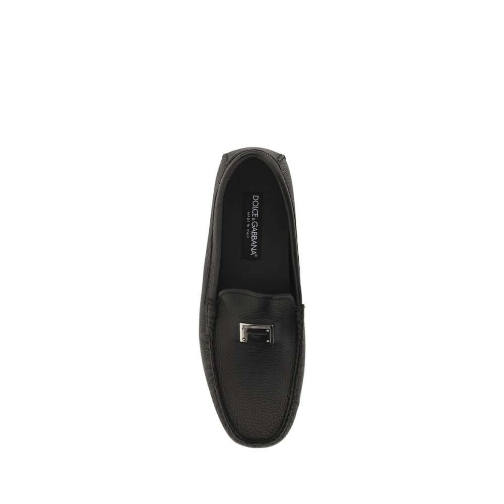 Dolce & Gabbana Black Rubber Slip-On Loafers with metal monogram plaque and non-slip sole, top view of calfskin shoe