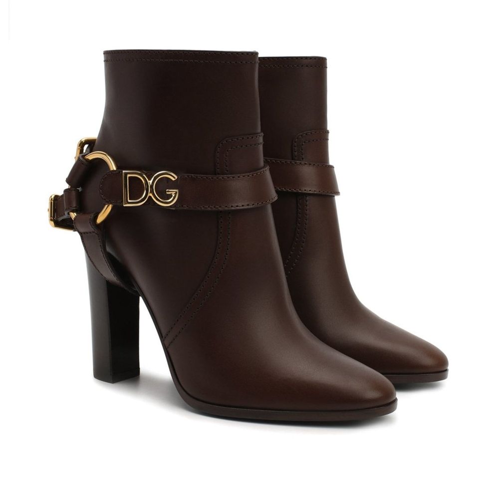 Dolce & Gabbana Brown Leather Ankle Boots with gold logo buckle, zip fastening, and high heel, made from 100% leather. Made in Italy.