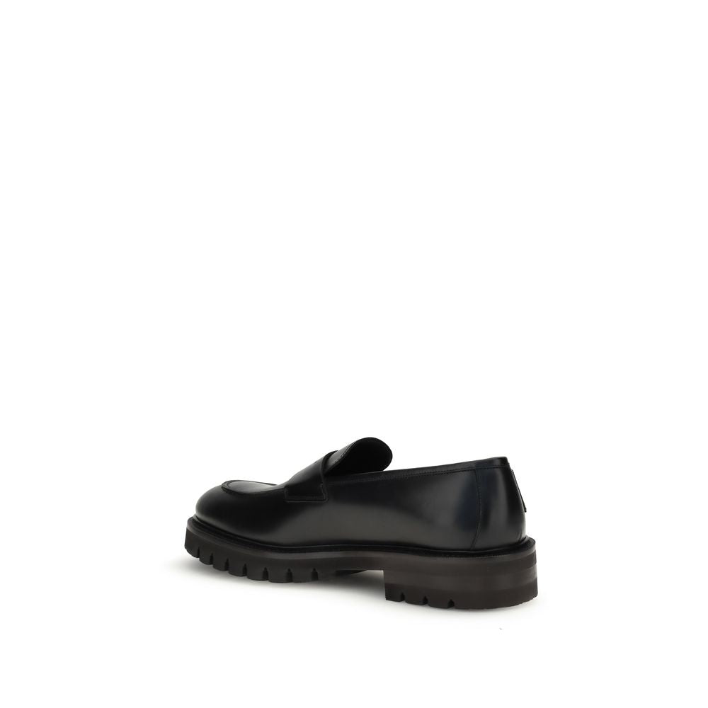 Ferragamo Black Rubber Slip-On Loafers with rounded toe, brushed calfskin upper, and bold rubber sole for a modern, elegant look.