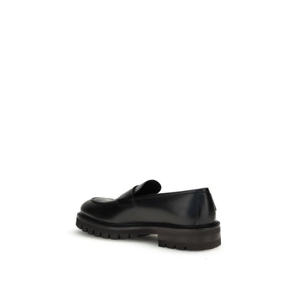 Ferragamo Black Rubber Slip-On Loafers with rounded toe, brushed calfskin upper, and bold rubber sole for a modern, elegant look.