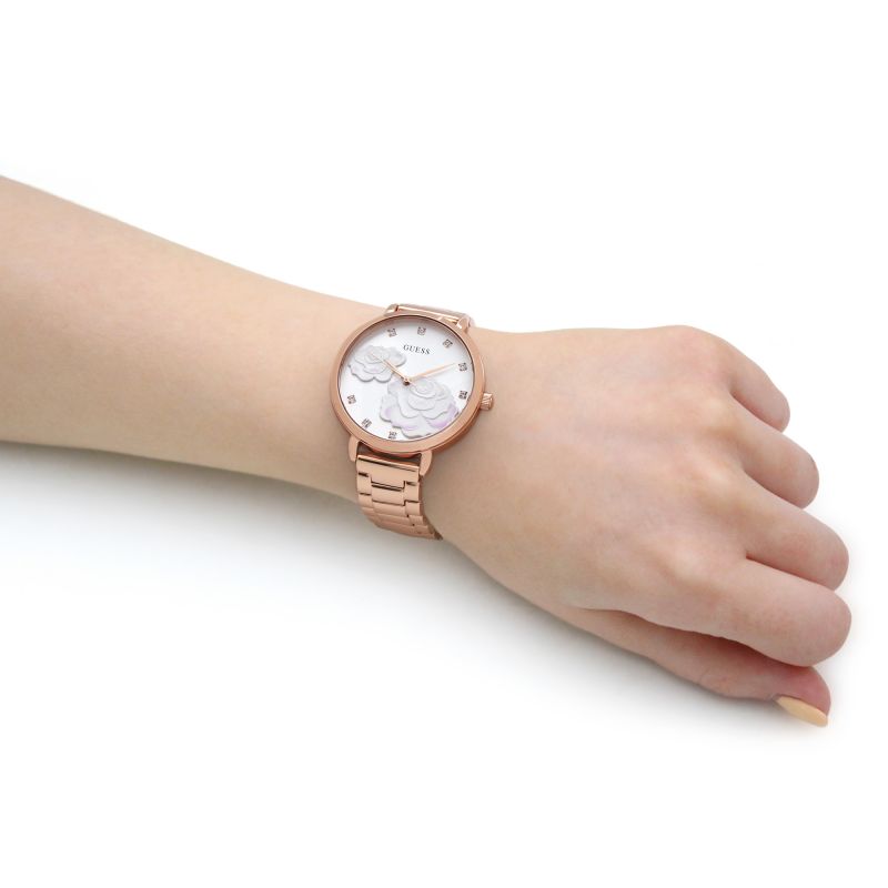 Model wearing GUESS Mod. GW0242L3 silver 925° quartz analog watch, rose gold color, on wrist, shown in mineral case, 38 mm diameter.