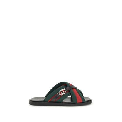 Gucci Black Polyamide Flat Sandals with green and red Web fabric and silver Interlocking GG logo on white background.