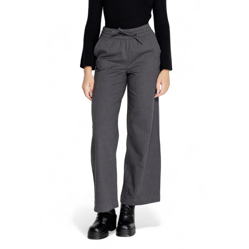 Woman wearing Jacqueline De Yong Gray Cotton Casual Pants, highlighting high waist and wide leg design for elegant comfort.