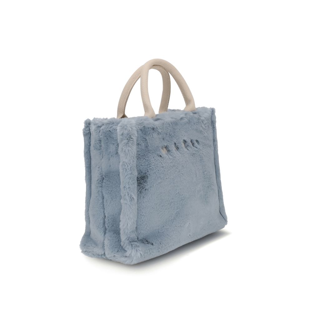 Marni Light Blue Polyester Handbag with playful fur lining and fabric handles, featuring Marni logo on front, versatile carrying options.
