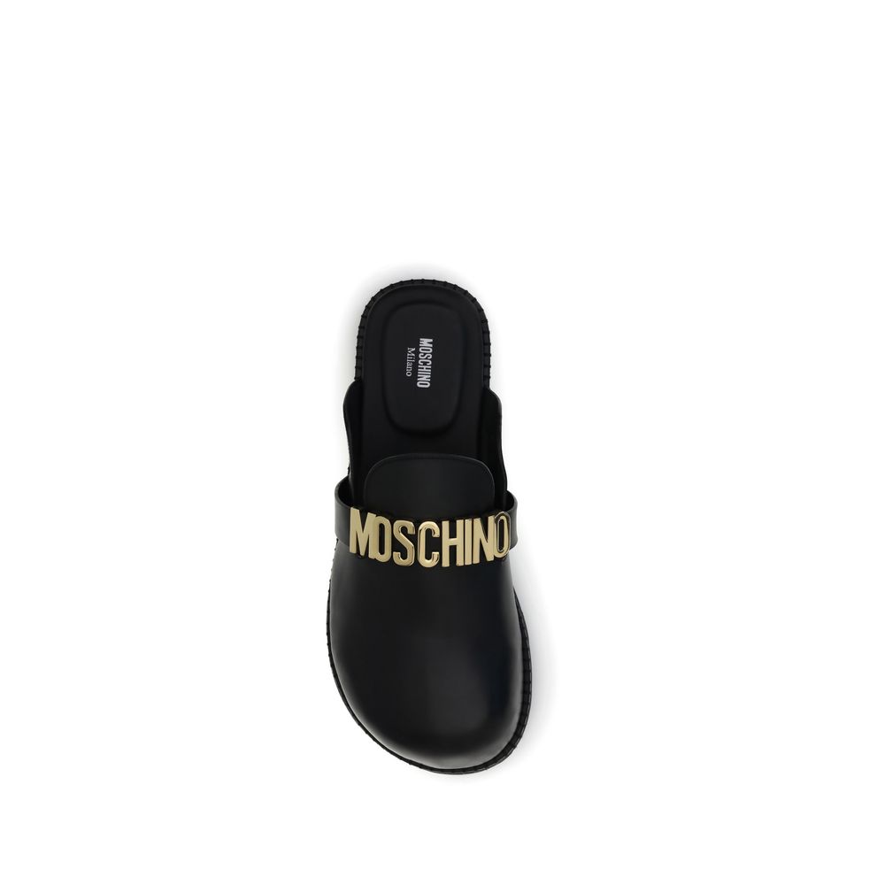 Moschino Black Calf Leather Bos Taurus Mules with golden logo plaque and rounded toe, top view.