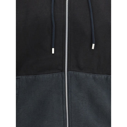 Close-up of Our Legacy Black Cotton Sweatshirt with drawstring hood and zip detail.