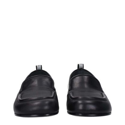 Premiata Black Leather Slip-On Loafers with round toe, low flat heel, and back logo detail.