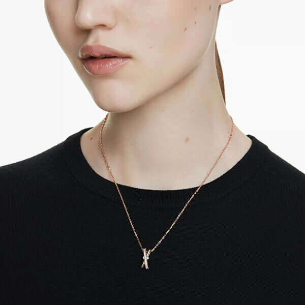 Woman wearing SWAROVSKI Mod. 5689788 Hyperbola Pendant Necklace with rose gold-tone plating.