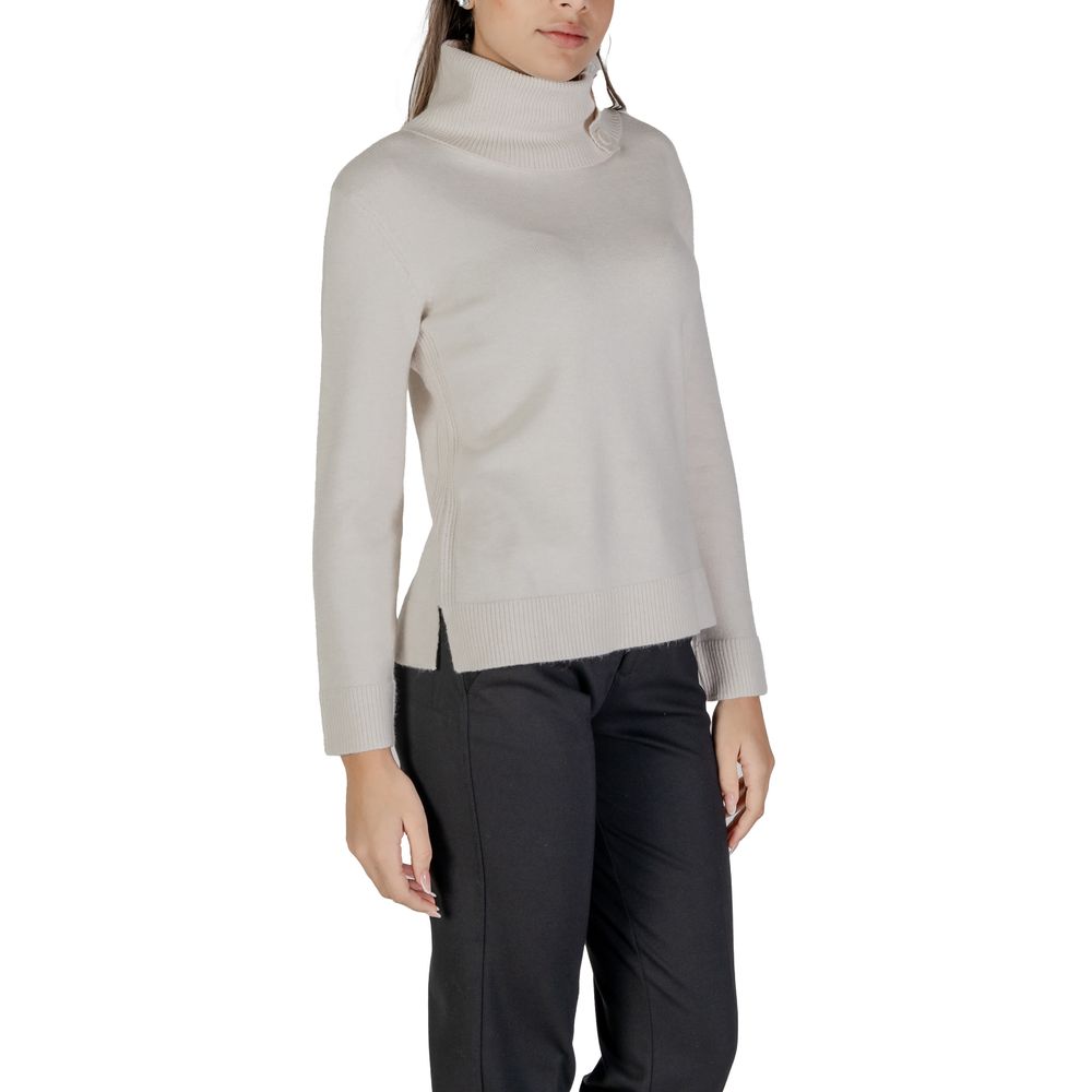 Woman wearing Street One Cream Viscose Turtleneck sweater with side buttons and high neck, paired with dark pants.