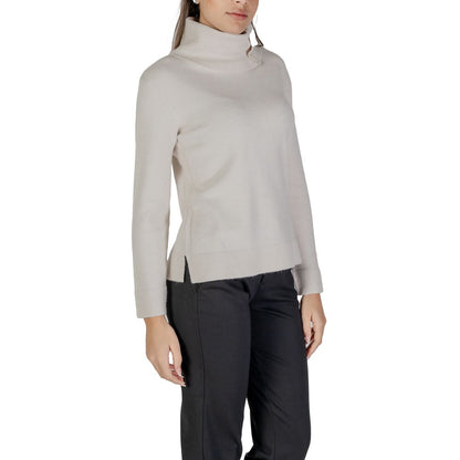 Woman wearing Street One Cream Viscose Turtleneck sweater with side buttons and high neck, paired with dark pants.