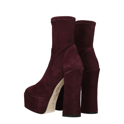 Stuart Weitzman Purple Leather Ankle Boots with high heels, suede material, and round toe in cordovan color.