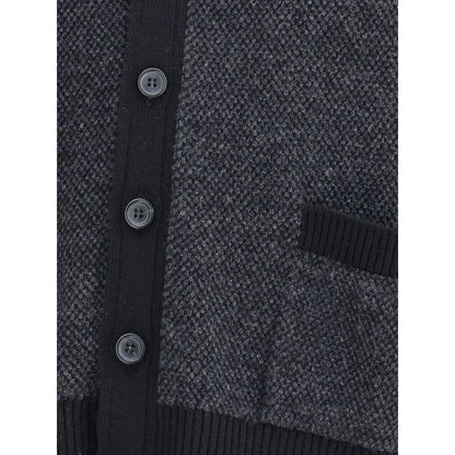 Close-up of Thom Browne Black Fleece Wool Cardigan with buttons and textured fabric.