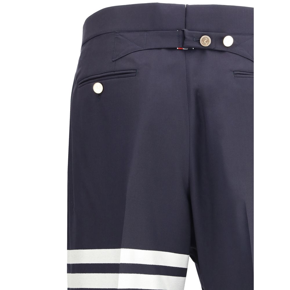 Close-up of Thom Browne Blue Wool Dress Pants with iconic bands and contrasting buttons.