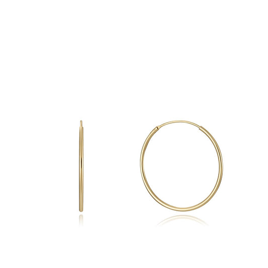 Simple gold hoop earrings on white background, showcasing minimalist design and elegance. Perfect for any occasion or outfit.